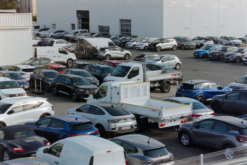 Large automotive group parking lot with cars