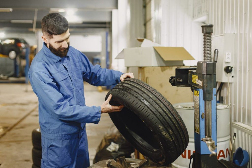 Mechanic holding car tire